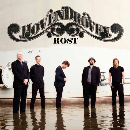 "Album cover featuring five men standing in water, dressed in dark attire."