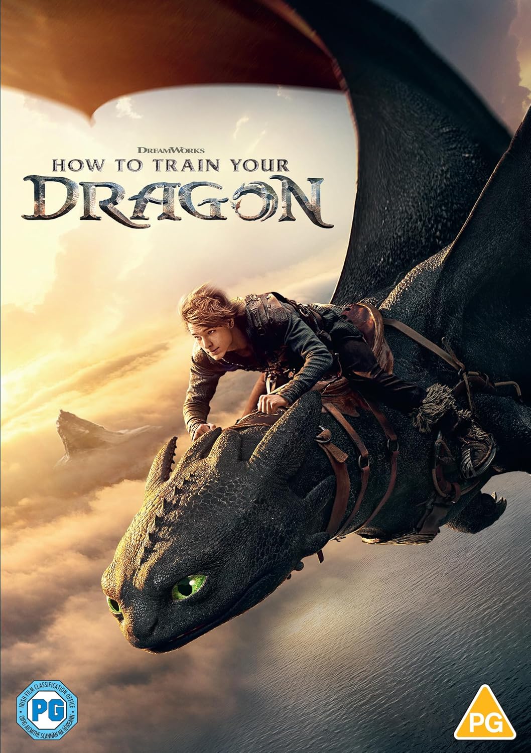 Hiccup rides his black dragon, Toothless, flying above clouds at sunset.