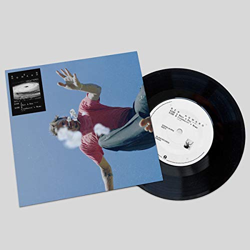 Vinyl record with cover art depicting a man mid-air against a blue sky.