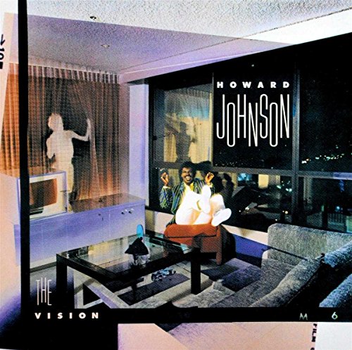 Howard Johnson sitting in a chair in a modern room with a night view.