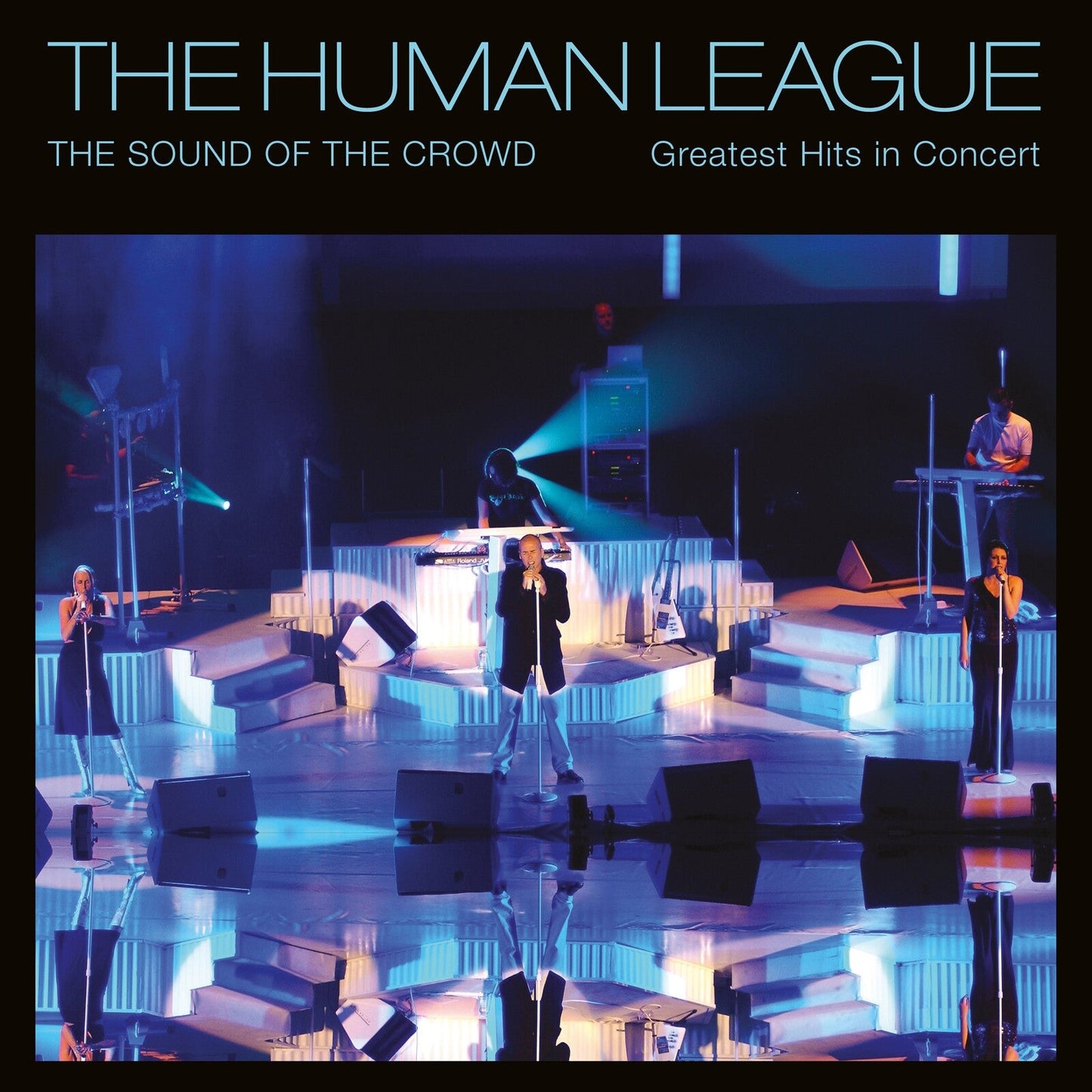 The Human League concert album cover with band members on stage.