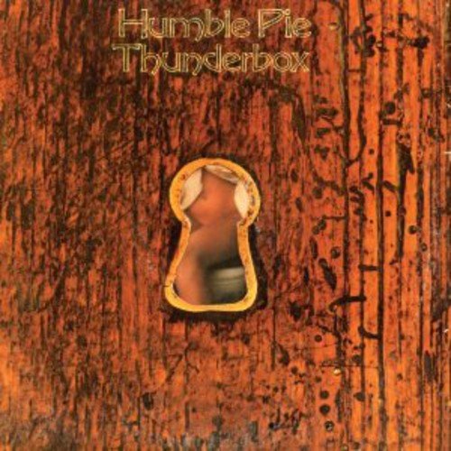 Album cover with a keyhole showing a nude woman, on a red wooden background.
