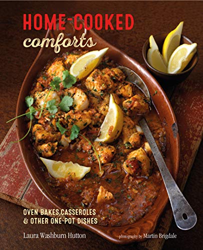 Cookbook cover featuring a browned chicken and sauce dish with lemon wedges.