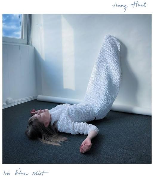 Album cover: woman in white lying on floor near a window.