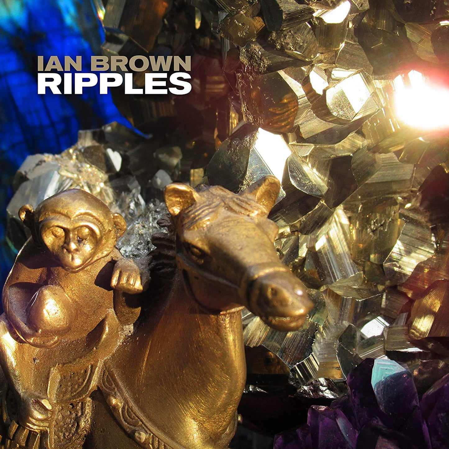 "Album cover featuring a golden statue with crystals and 'IAN BROWN RIPPLES' text."