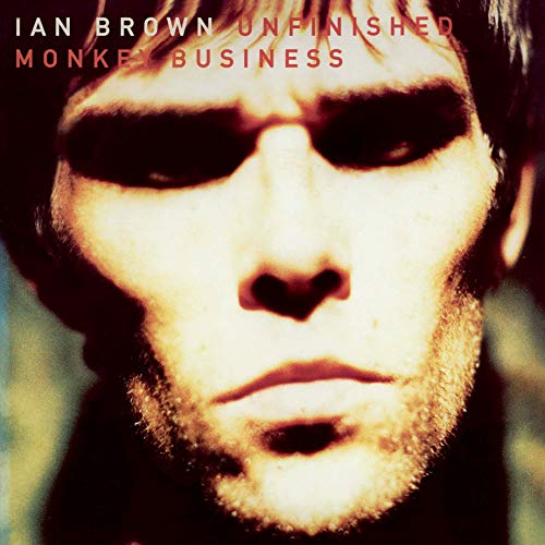 Close-up portrait of Ian Brown with dark eyes and stubble.