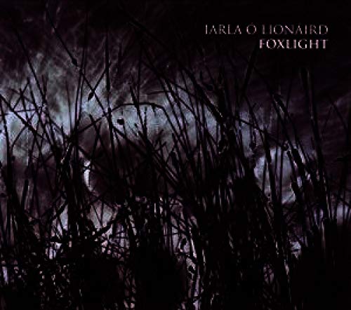 CD cover for Iarla Ó Lionaird’s “Foxlight” with dark, silhouetted foliage.