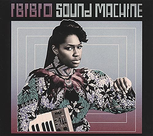 Album cover featuring a woman with a keyboard, patterned clothing.