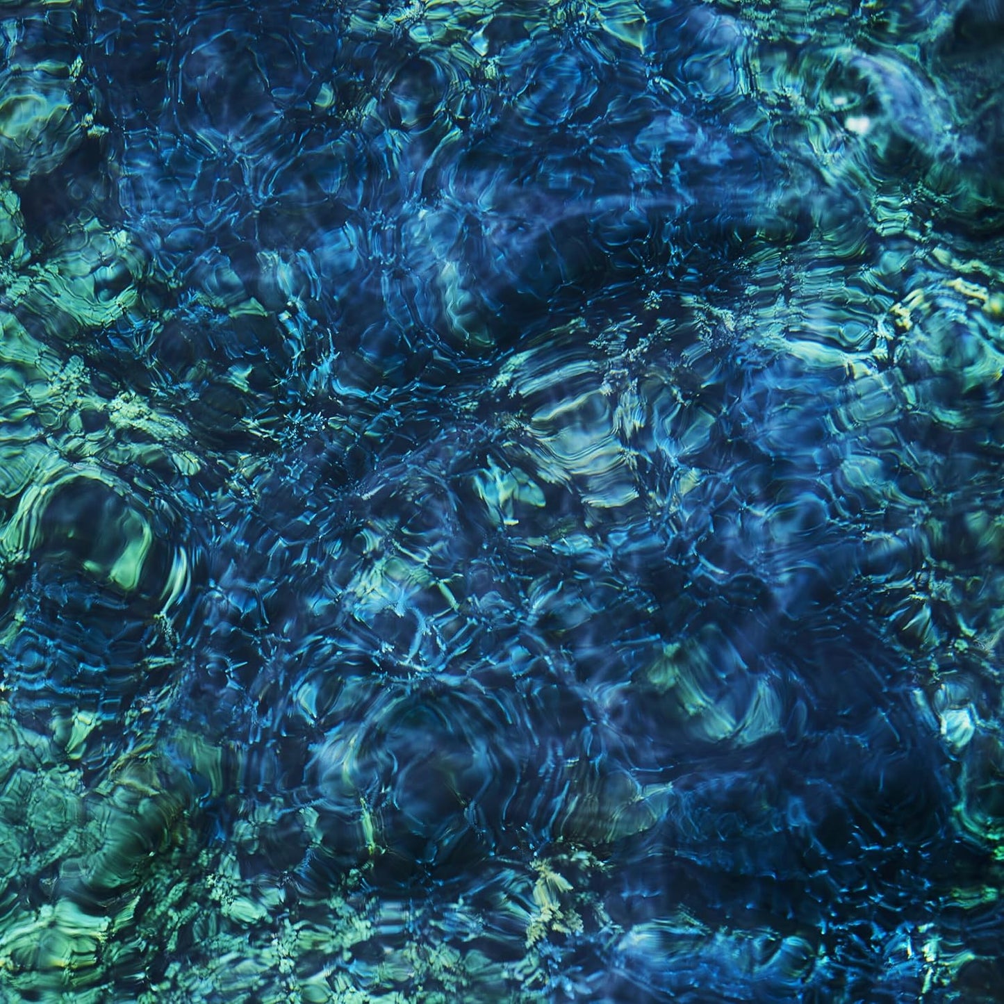 Abstract blue and green water ripples, album cover art.