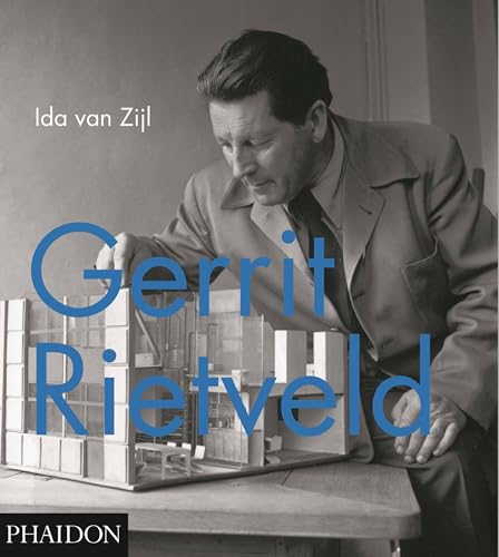 Black and white portrait of Gerrit Rietveld beside an architectural model.