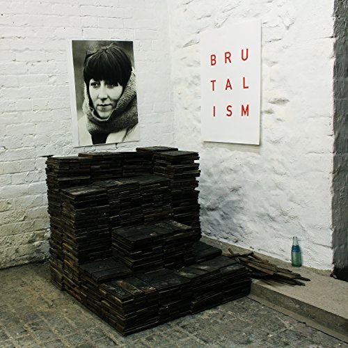 Idles’ “Brutalism” vinyl album cover art staged with stacked wood.