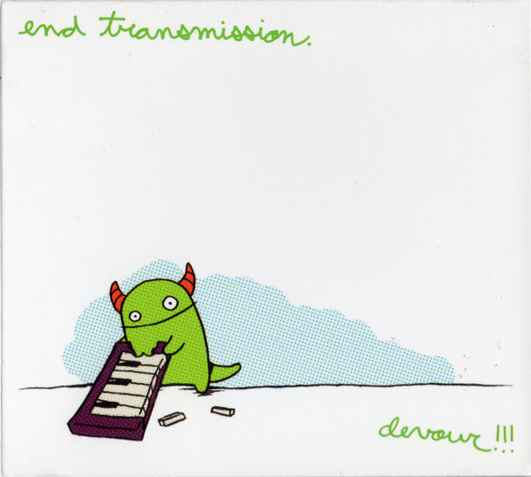 Green monster playing a small red keyboard with scattered tapes.
