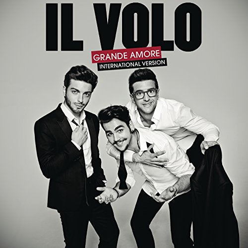 Il Volo trio in suits, black and white with a red banner.