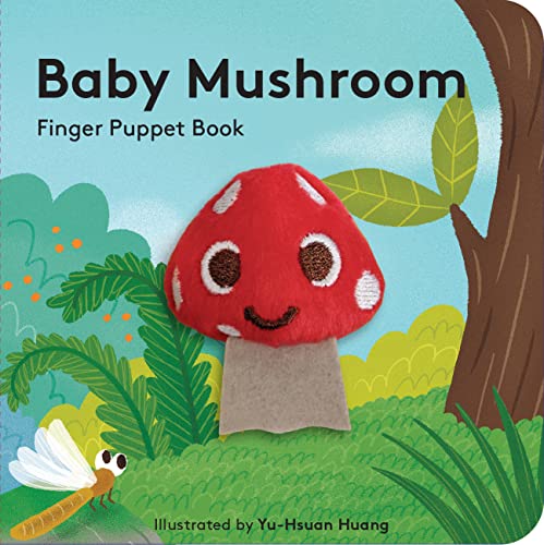 A felt mushroom finger puppet with a smiling face on a forest-themed book cover.