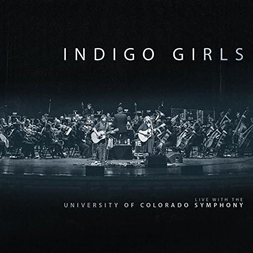 Indigo Girls with orchestra on stage, album cover in grayscale.