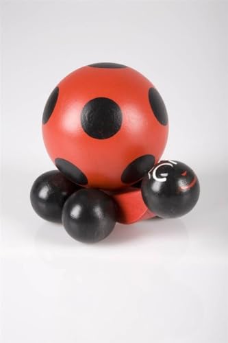 Red wooden snail with black spots, viewed from the side on white.