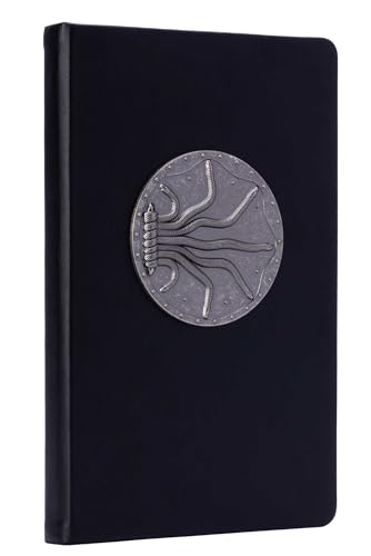 Black hardcover journal with a silver, circular serpent design on the cover.