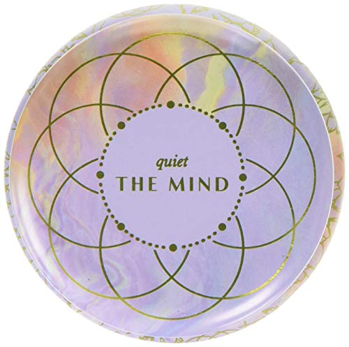 Round tin candle lid with gold geometric design and āquiet the mindā text.