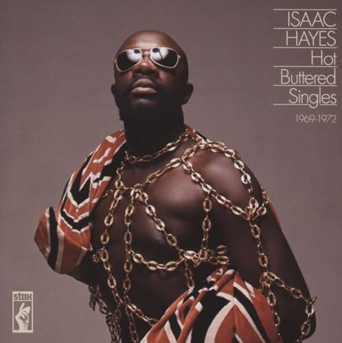 Isaac Hayes wearing sunglasses and gold chains with patterned fabric against a grey background.