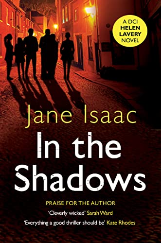 Book cover showing silhouettes of people walking down a cobblestone street at night.