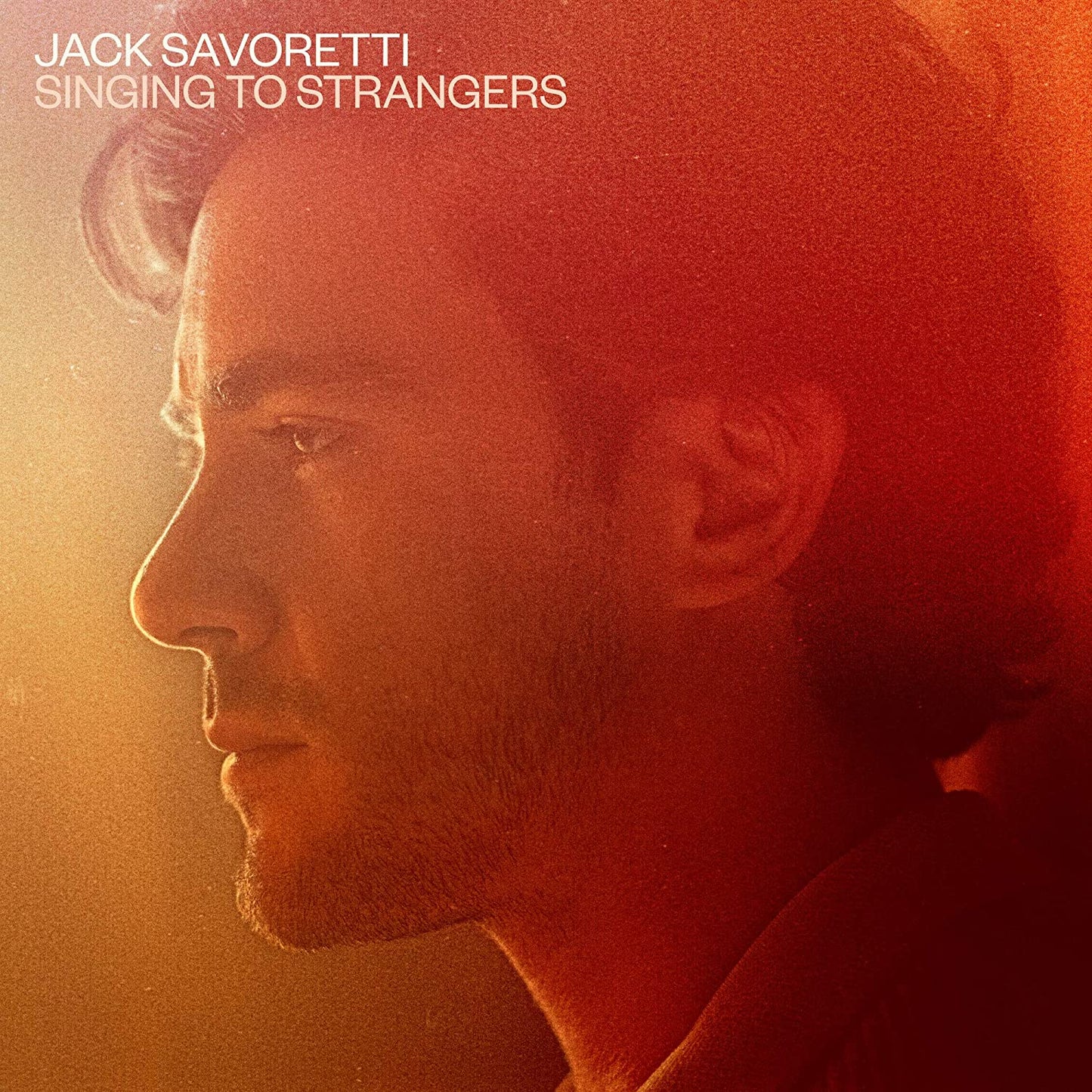 Album cover featuring a close-up of a man's profile in warm, red-toned lighting.