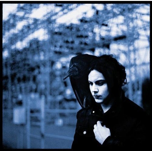 Jack White with a black bird on his head, blue-toned image.