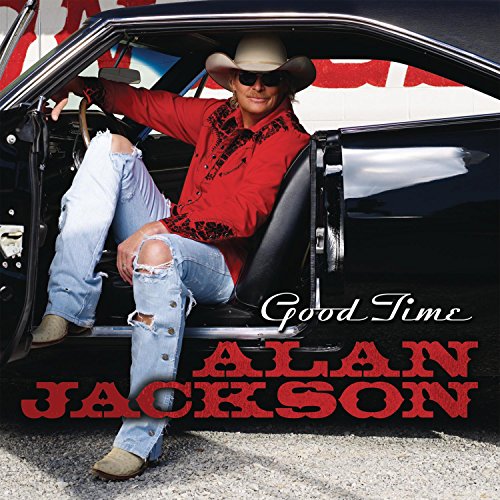 Alan Jackson in a cowboy hat leaning against a classic car.