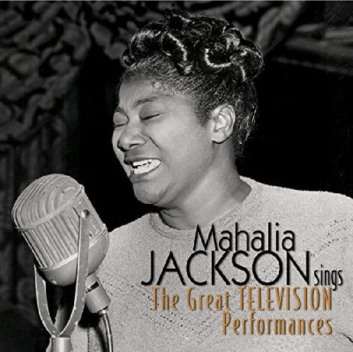 Mahalia Jackson singing into a vintage microphone, black and white portrait.