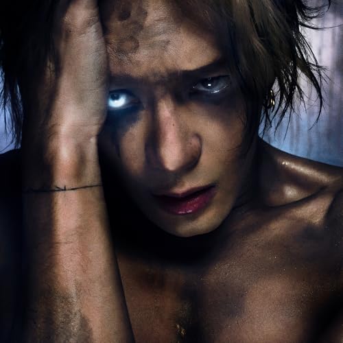 Jackson Wang album cover: close-up of a man with intense gaze.
