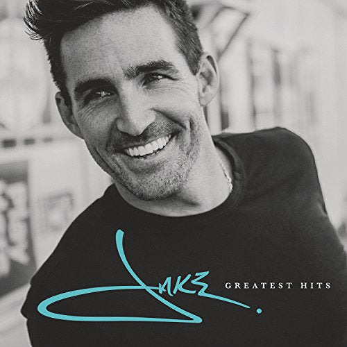 Black and white portrait of Jake Owen with "Greatest Hits" text on his shirt.