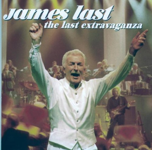 James Last on stage with arms raised, orchestra in background.