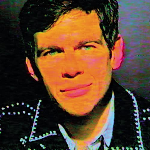 Close-up of James Righton with distorted, colorful overlay and patterned jacket.