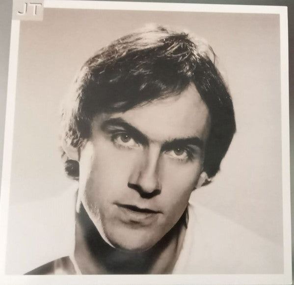 Black and white portrait of James Taylor on a vinyl record cover.