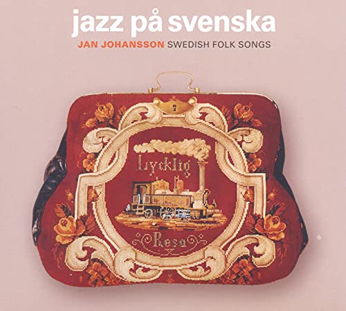 Album cover featuring a red embroidered handbag with a train motif on a pink background.