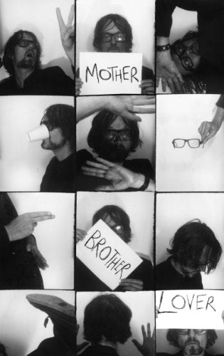 Black and white photo grid featuring a man holding lyric cards.