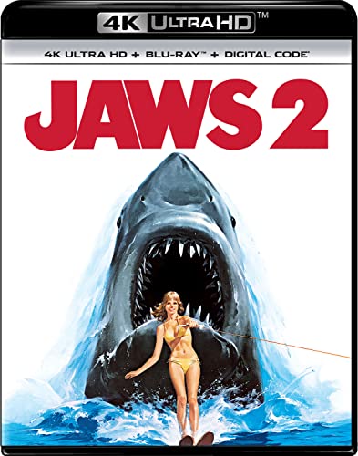 Jaws 2 Blu-ray cover featuring a giant shark leaping behind a woman in swimwear.