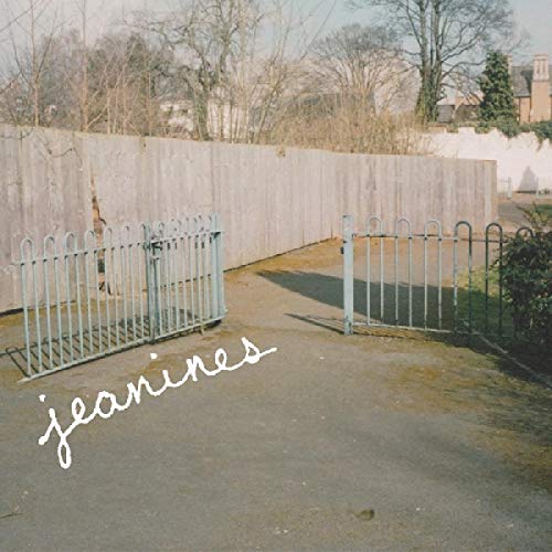 CD cover with a gray wall, metal gate, and handwritten text.