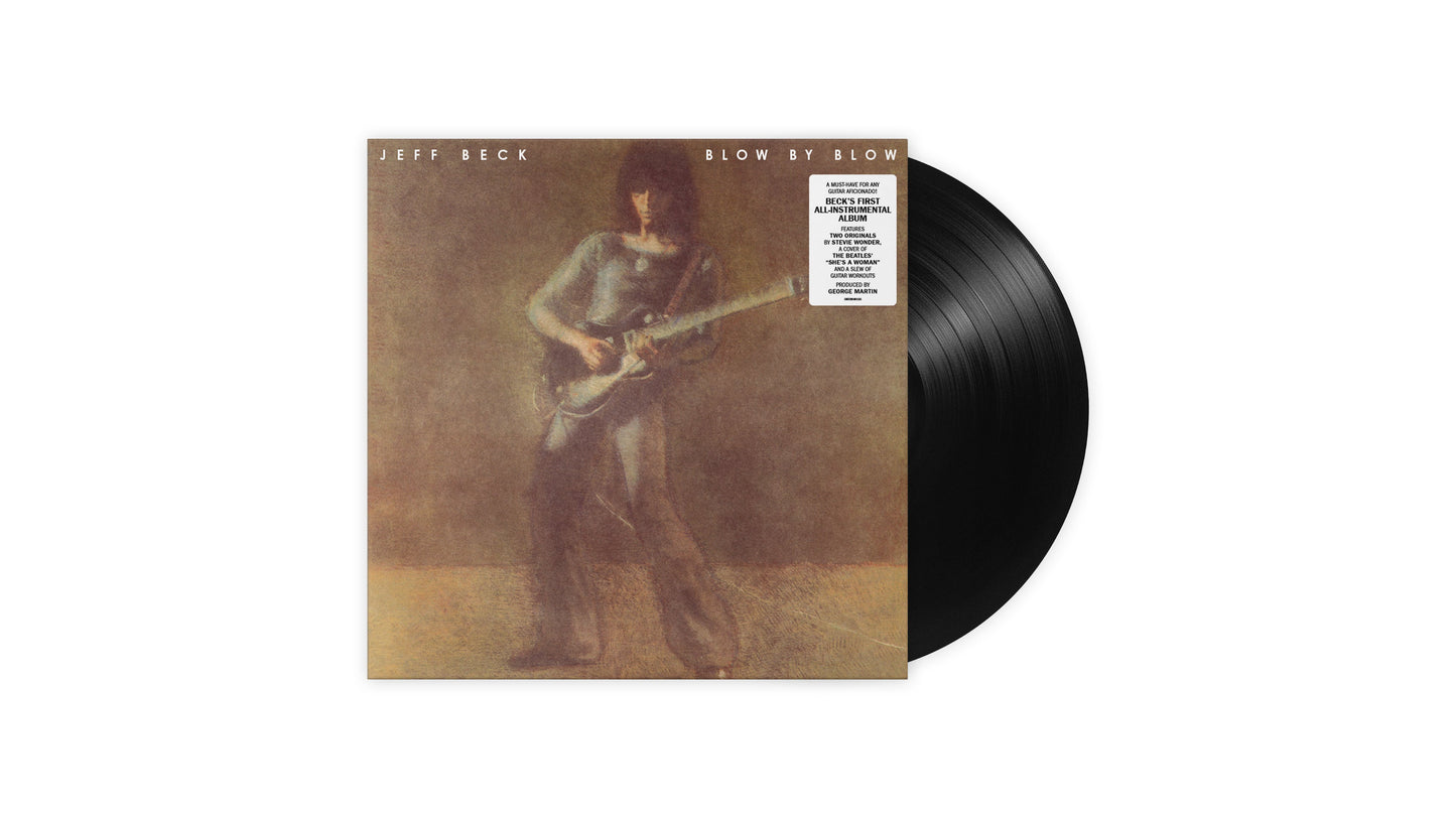 "Vinyl record sleeve with a man playing guitar, partially covering the black vinyl."