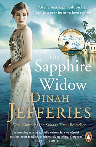 Book cover: woman in a pale dress, ocean backdrop, title “The Sapphire Widow”.