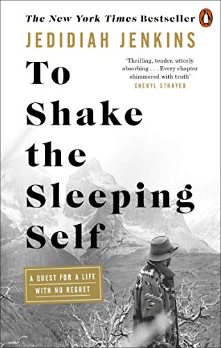 Book cover showing a person in a hat looking at mountains in black and white.