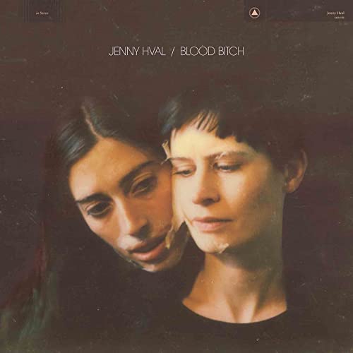 Album cover featuring two women close together against a dark, textured background.