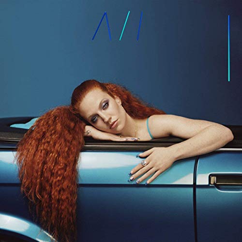 The alt text for the image is: "Woman with long red hair leaning on a blue car."