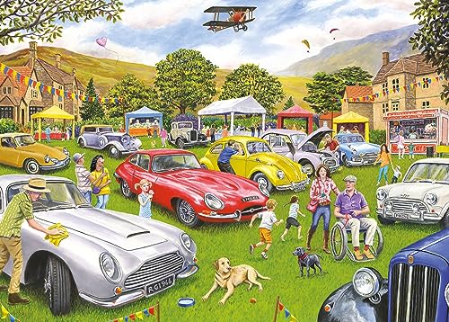 Vintage cars and people gathered in a village for a motor show.