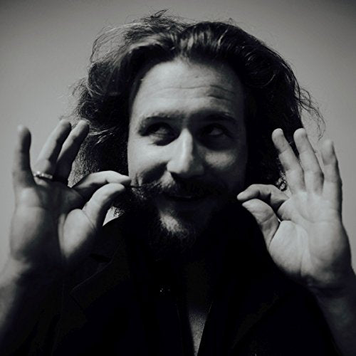 Black and white portrait of Jim James with outstretched hands framing his face.