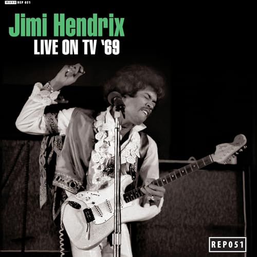 Black and white photo of Jimi Hendrix playing a white electric guitar on stage.