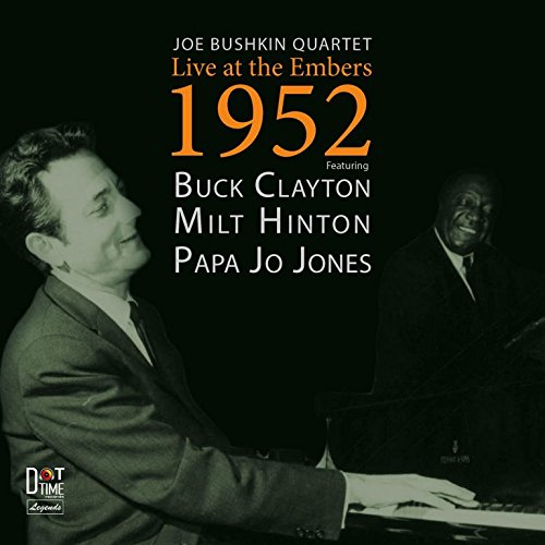 "CD cover with black background, featuring two men playing piano, text overlay."