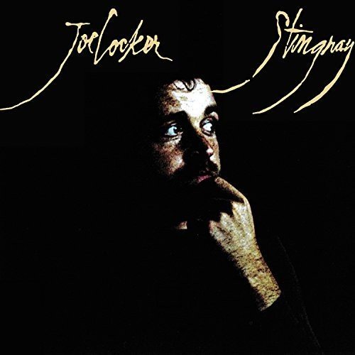 "Album cover with a man touching his chin, against a black background."