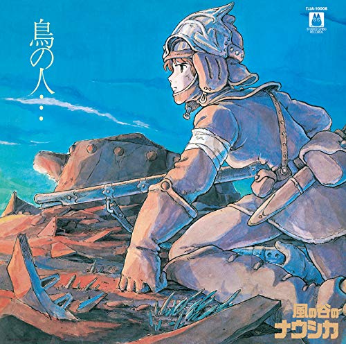 Nausicaä in helmet and cape, standing amidst a desolate landscape.