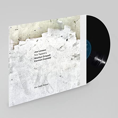 Vinyl record with white album cover featuring abstract textured art.