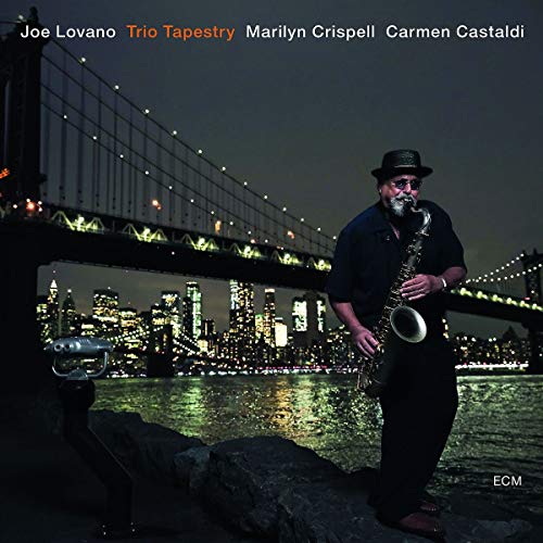 "Album cover featuring a man playing saxophone by a lit city bridge at night."